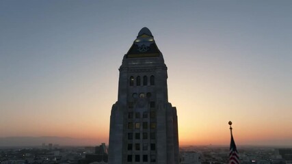 A majestic, silhouetted skyscraper stands tall against a vibrant, colorful sky during a beautiful and serene sunset, casting a dramatic shadow over the city. - Powered by Adobe