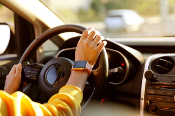 Woman behind steering wheel of modern car, closeup
