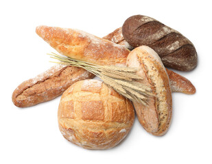 Different types of bread and spikes on white background, top view