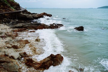 Rocky beach at Khao Laem Ya-Mu Ko Samet National Park, Thailand. A metamorphic rock formed by...