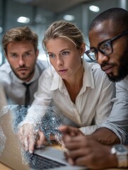 Group of Professionals Analyzing Data on Laptop in Modern Office