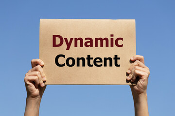 Dynamic content text on paper holding by a woman's hand with blue sky background
