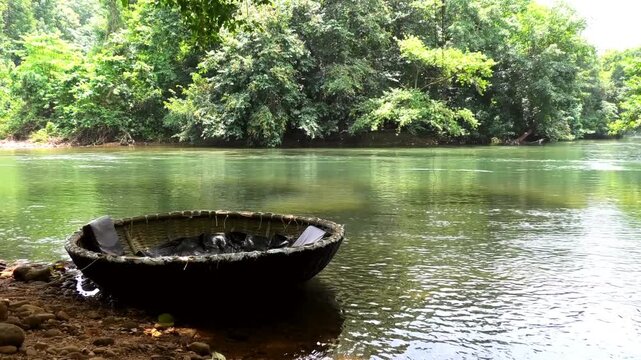 A coracle boat moored on the banks of Kallar river at Adavi, Pathanamthitta, Kerala, India | Adavi Eco Tourism entertainments