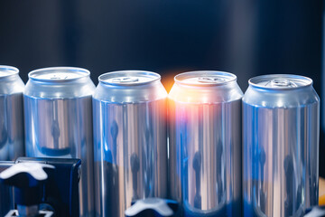 Aluminum beer cans on conveyor belt in beer factory, brewing and packaging process