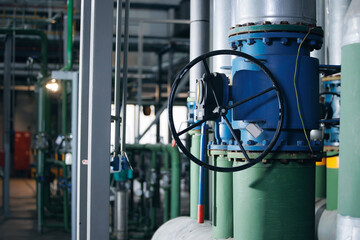 Closeup valve, steel pipelines, and ladders of industrial factory zone of gas thermal power plant