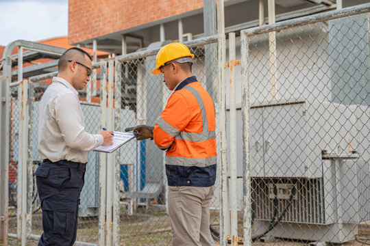 Asian electrical engineer inspect the electrical systems, Electric construction and maintenance services throughout, Electric Power Transmission Infrastructure, Highest voltage transmission