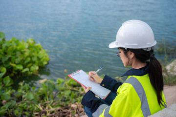 Environmental engineers work at the water storage plant, check the pH of the water, check the...