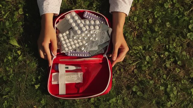First aid kit. First aid kit close-up. First aid kit and medicines. Slow motion. High quality video in 4K format.
