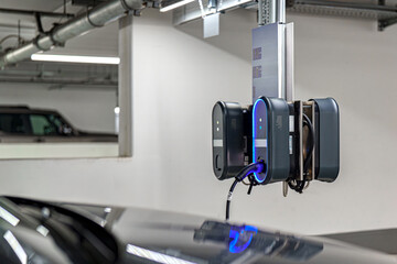 Electric vehicle charging station in a modern underground parking garage