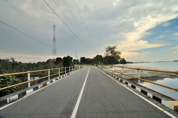 Empty road alongside beautiful coast in Belitung Island, Indonesia. 