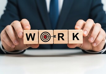 Obraz premium Business professional holding wooden blocks spelling out the word work with a target symbol
