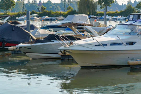 Boating activities at a serene marina during a sunny afternoon in a picturesque waterfront location