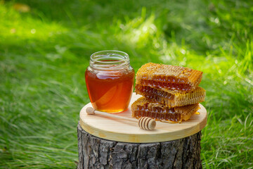fresh honey on a background of garden and flowers. Selective focus