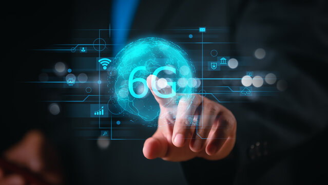 A businessman using a high-tech digital interface with 6G elements, illustrating the impact of advanced wireless networks on business, communication, and global technology.