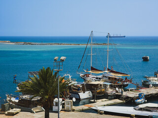 Sailboats and palm tree in the harbor of Famagusta, Cyprus