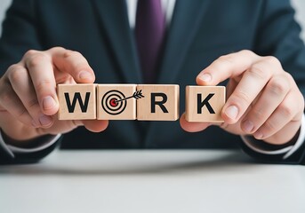 Businessman assembling wooden blocks spelling out the word work with a target symbol
