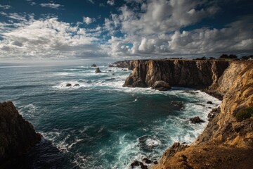 Obraz premium Coastal cliffs meet churning sea under dramatic sky