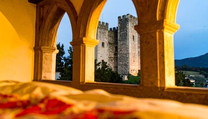 Stone archways frame a medieval castle.