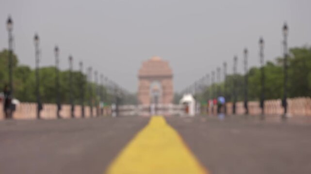 Bokeh view of Kartavya Path in front of India Gate during the heatwave season in New Delhi, India. Blurred background footage.