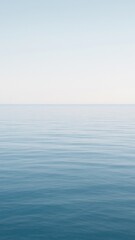 Obraz premium Calm ocean under clear sky.