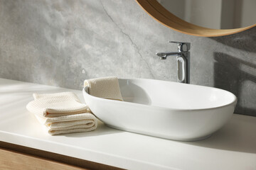 Clean waffle towels near sink in bathroom