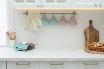 Clean dishware, waffle towels and pretzels on countertop in kitchen