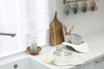 Clean dishware and waffle towels on countertop in kitchen