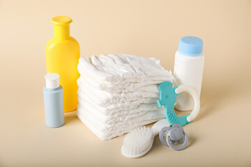Baby accessories and cosmetic products on beige background
