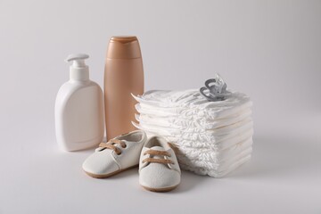 Baby accessories and body care products on light grey background