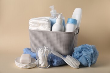 Baby accessories and body care products on beige background