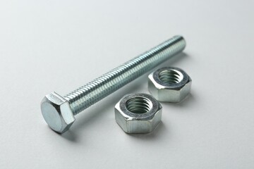 Metal bolt and nuts on white background, closeup. Hardware tool
