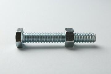 Metal bolt and nut on white background. Hardware tool