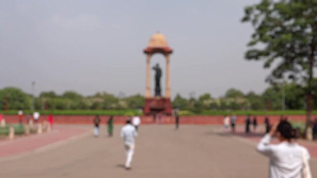 Bokeh view of tourists visit Netaji Subhas Chandra Bose Canopy Delhi near India Gate in New Delhi, India. Blurred background footage.