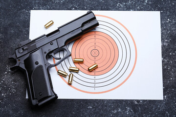 Many metal bullets, gun and shooting target on grey table, flat lay