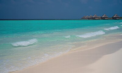 Fototapeta premium Turquoise water lapping at a sandy shore, thatched bungalows in the distance