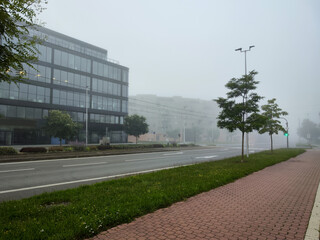 Foggy morning street with modern office building in Olomouc,
