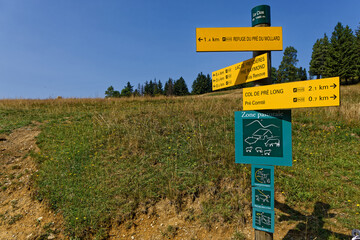 SAINT-MURY, FRANCE, August 16, 2025 : Direction panels at the start of several mountain paths in Belledonne mountain range