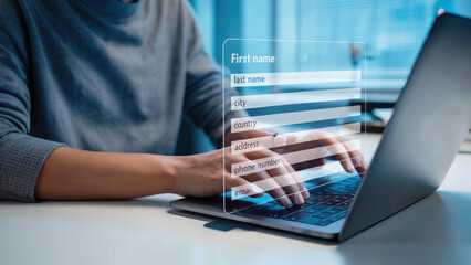 Person filling online form on laptop, privacy concerns with modern digital technology