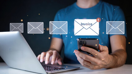 Person checking online invoice notification on phone and laptop for efficient digital finance management