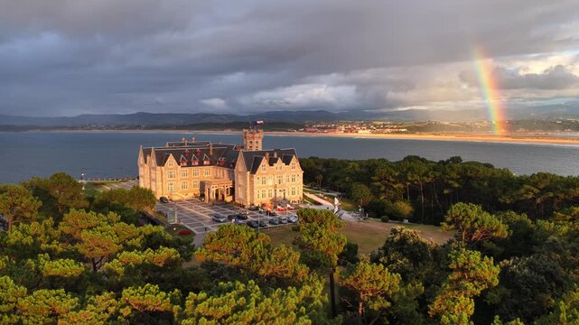 Aerial view of Magdalena Palace in Santander, Cantabria Spain, drone shot of Santander at sunset with a rainbow, tourism in northern Spain