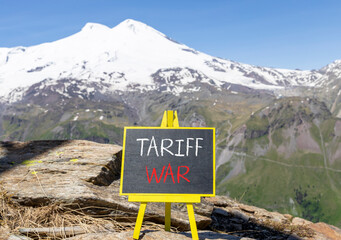 Trade tariff war symbol. Concept word Tariff war on beautiful black blackboard. Beautiful stone...