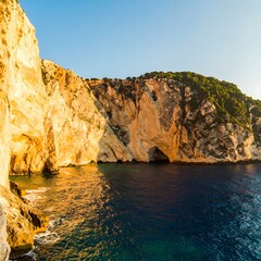 Coastal cliffs meet a tranquil sea