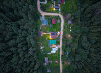 aerial view on the part of the small settlement between the forest. life between fores