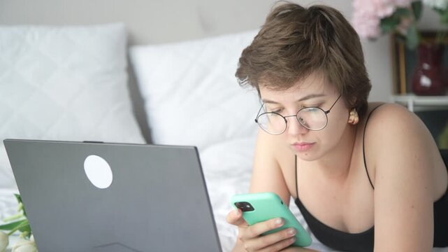 A young beauty blogger expresses authentic emotions while working and talking on the phone &ndash; from focused concentration to joyful reactions. Perfect for lifestyle and digital content