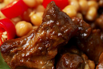 juicy grilled meat served with chickpeas, red chili pepper, and fresh herbs. Rich textures and vibrant colors highlight the freshness