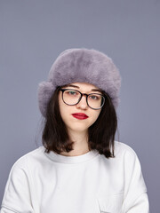Girl wearing a hat in a studio setting