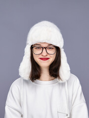 Girl wearing a warm hat posing indoors