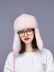 Girl in soft hat striking a pose indoors