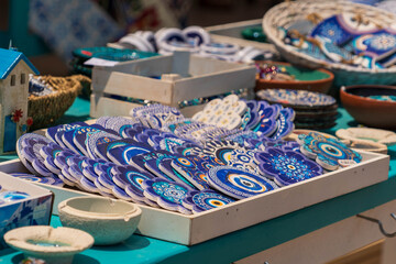 Traditional Greek souvenirs with blue and white patterns displayed on a market stall in Crete