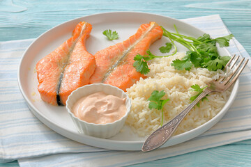 baked salmon steaks with rice, cilantro and sauce